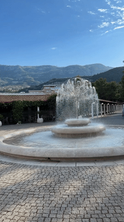 Tourist photographs fountain plaza in Budva, Montenegro
