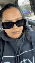 Woman in sunglasses sits in driver's seat, Dronten