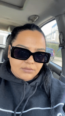 Woman in sunglasses sits in driver's seat, Dronten
