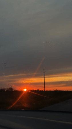 Sunset observed from moving vehicle in rural Alexandrovka, Russia