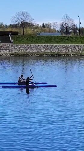 Morning kayakers paddle calm waters in Jelgava, Latvia