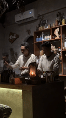 Bartenders craft cocktails at candlelit Ubud establishment