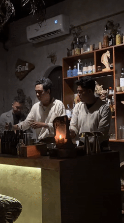 Bartenders craft cocktails at candlelit Ubud establishment