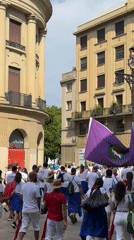 White-clad crowd moves through Pamplona's cobblestone streets