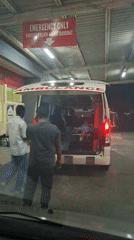 Ambulances gather at Banda Aceh emergency facility during evening hours
