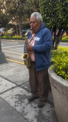Street musician performs near soccer sculpture in Mexico City