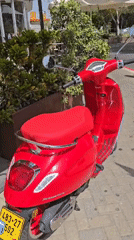 Red Vespa and Hebrew bookshelf spotted in Even Yehuda