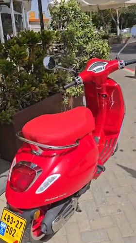 Red Vespa and Hebrew bookshelf spotted in Even Yehuda