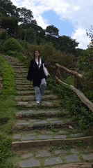 Woman walks stone paths in rural Vietnamese village