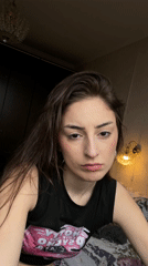 Young woman photographs self indoors in Moscow apartment