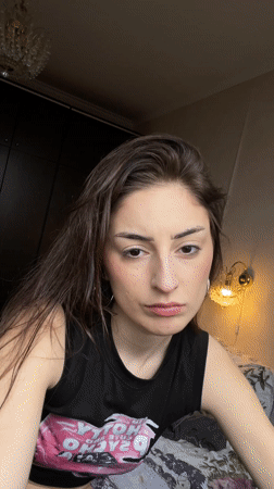 Young woman photographs self indoors in Moscow apartment