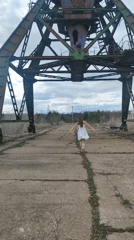 Woman walks barefoot on cracked road in Chaikovsky