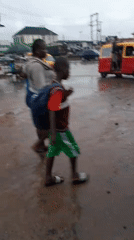 Colorful minibuses navigate flooded urban streets