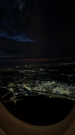 Nighttime aerial view captured over illuminated Schwechat from airplane