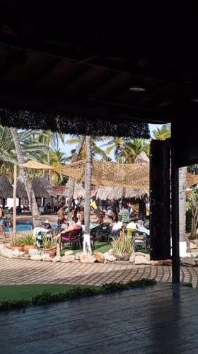 Resort guests perform group exercise routine in Porlamar pool area