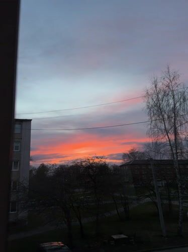 Vibrant sunset illuminates sky over Reshetnikovo, Russia