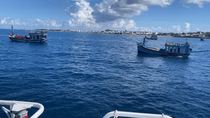 Fishing boats approach shore near Phú Quý coast
