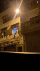 Nighttime street observation in Safi, Morocco shows illuminated building