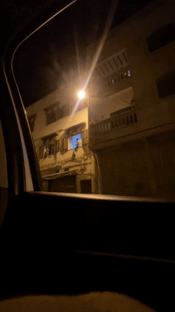 Nighttime street observation in Safi, Morocco shows illuminated building