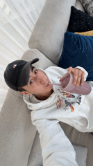 Young man enjoys purple smoothie on couch in Mexico