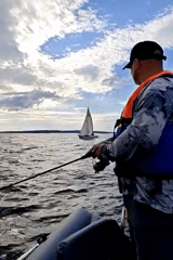 Sailing and fishing on a grey afternoon near Chaykovsky