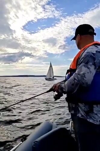 Sailing and fishing on a grey afternoon near Chaykovsky
