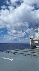 Ship passenger films calm ocean views, crane equipment