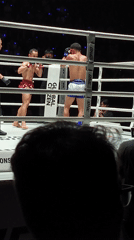 Two men boxing in ring, red vs white shorts