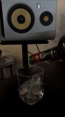 Amber liquor poured over ice in Sofia evening