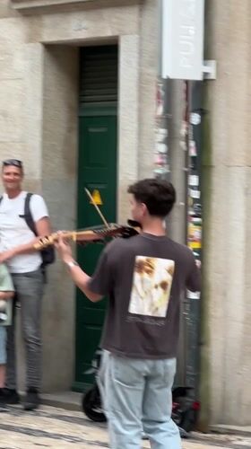 Street performers draw crowds in historic Porto, Portugal