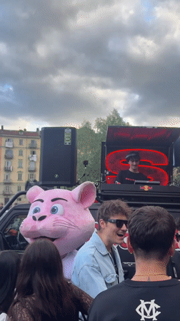 DJ performs outdoor set with pink mascot in Turin
