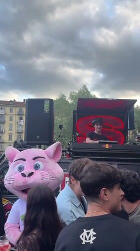 DJ performs outdoor set with pink mascot in Turin