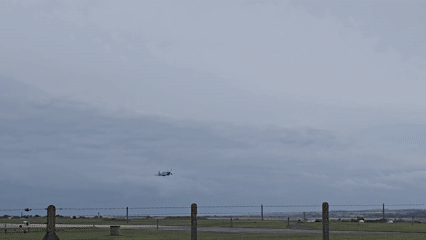 Vintage fighter plane spotted flying through cloudy skies