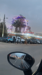 Evening drive past illuminated amusement park in Morocco