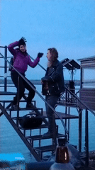 Couple observed on waterside staircase in Chaikovsky at dusk