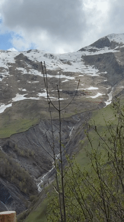 Snow-capped mountain range documented in Georgia's countryside