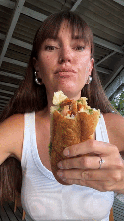 Woman eats large sandwich in North Kuta, Indonesia