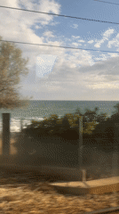 Train passenger captures coastal view in El Masnou, Spain