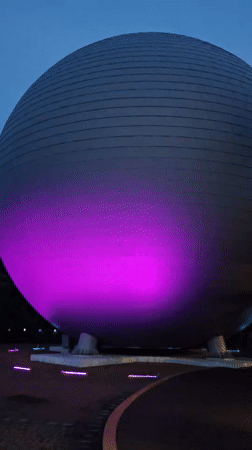 Jeju Science Center glows at dusk alongside a robot barista