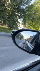 Child's reflection caught in car mirror on Cheboksary road