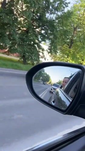 Child's reflection caught in car mirror on Cheboksary road