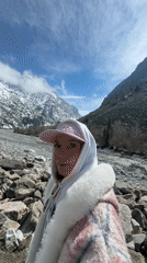 Woman explores mountain river valley in Kyrgyzstan spring morning