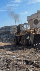 Heavy machinery clears debris at outdoor site in Badagry