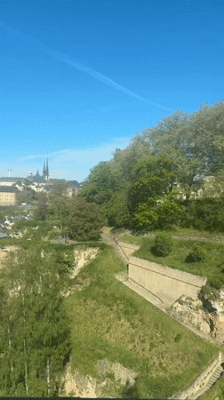Clear morning skies over Luxembourg City with aircraft contrail