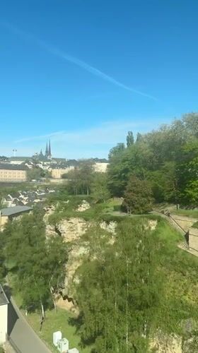 Clear morning skies over Luxembourg City with aircraft contrail