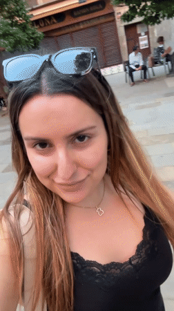 Woman films herself walking outdoors in Barcelona