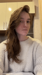Young woman with brown hair captured in brief video clip