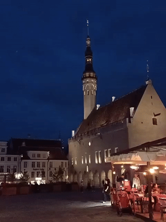 Tallinn's Town Hall Square glows at dusk on a summer evening
