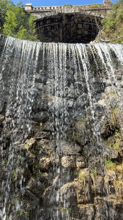 Morning scenes captured: waterfall and bronze eagle statue in Budapest