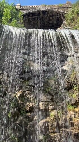 Morning scenes captured: waterfall and bronze eagle statue in Budapest